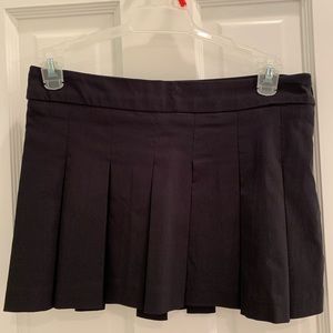Black pleated miniskirt.
